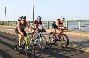 Hilary on a bike crossing a bridge