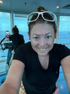 Hilary riding a stationery bike on the windstar cruise